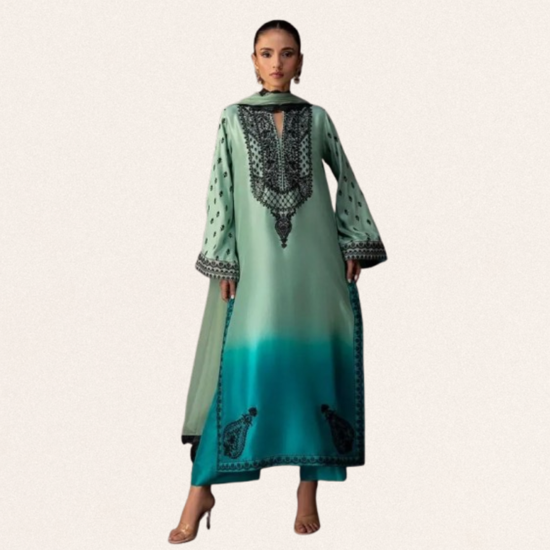 Unstitched emerald green printed silk suit fabric with elegant floral patterns for wedding and formal wear.