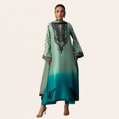 Unstitched emerald green printed silk suit fabric with elegant floral patterns for wedding and formal wear.