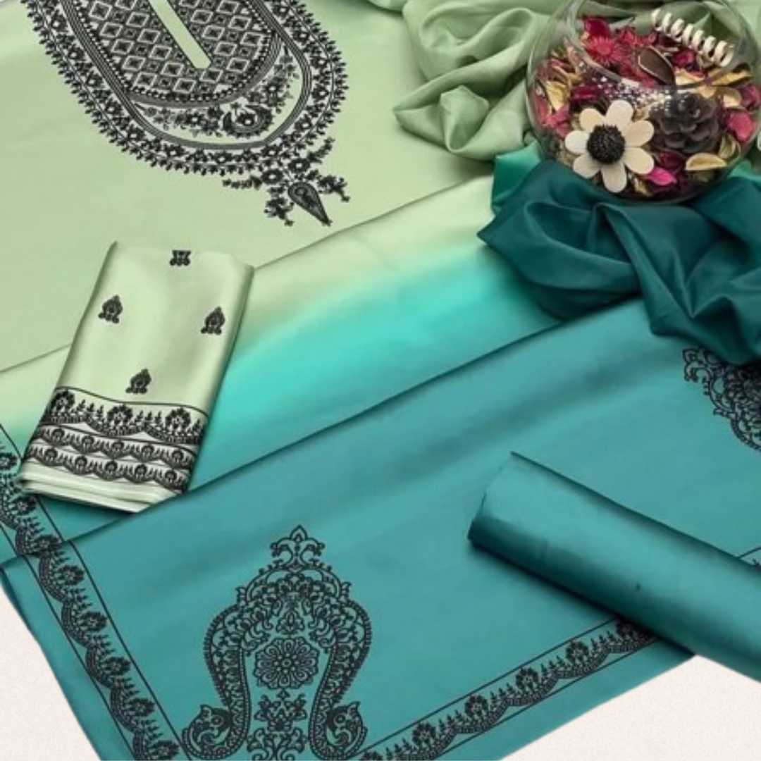 Unstitched emerald green printed silk suit fabric with elegant floral patterns for wedding and formal wear.
