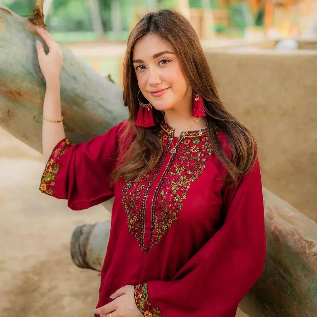 Elegant maroon stitched linen set with unique collar neckline and contrasting embroidery on sleeves and pocket.