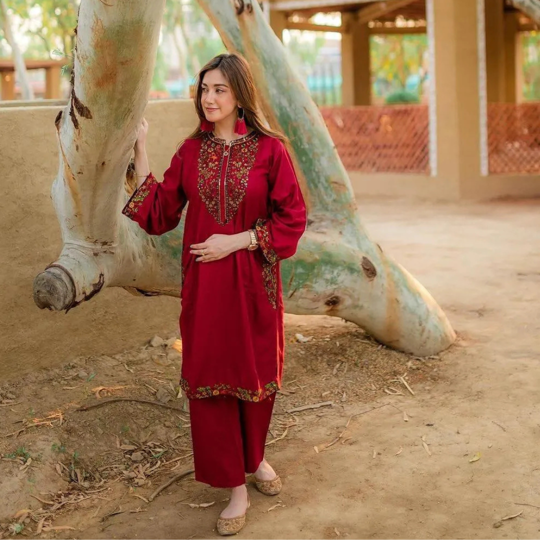 Elegant maroon stitched linen set with unique collar neckline and contrasting embroidery on sleeves and pocket.